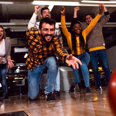 Guy Bowling with Left Hand with Friends