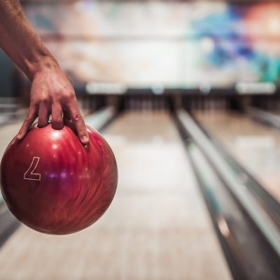 Hand Holding a Red Bowling Ball