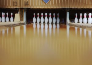 ground view of bowling pins at the end of bowling alley