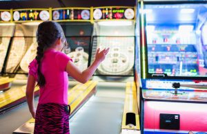 young girl playing arcade games