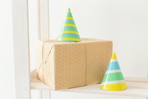 birthday party hats and present on a shelf