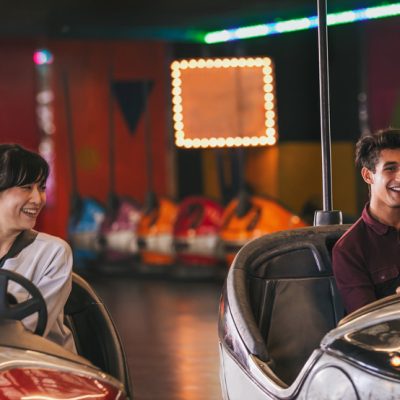 Two young friends ride bumper cars for fun things to do in Columbus, GA